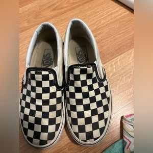 Slip on checkered vans.